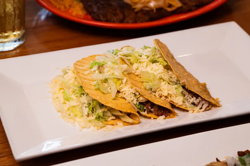 Crispy tacos on a white plate
